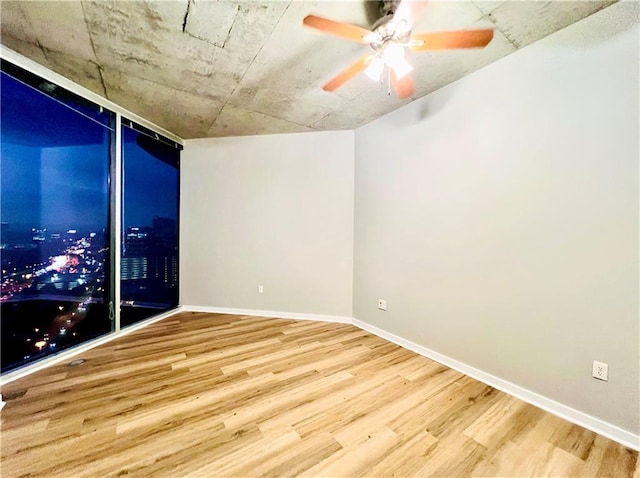 unfurnished room with hardwood / wood-style flooring and ceiling fan