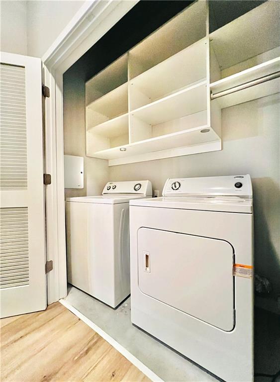 washroom featuring light hardwood / wood-style flooring and washer and clothes dryer