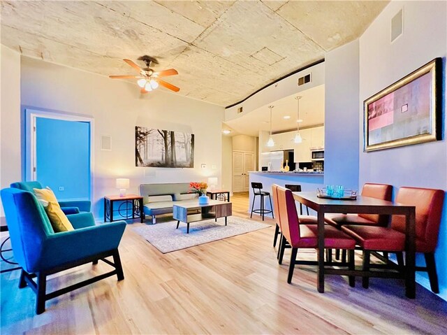 dining room featuring light hardwood / wood-style flooring and ceiling fan