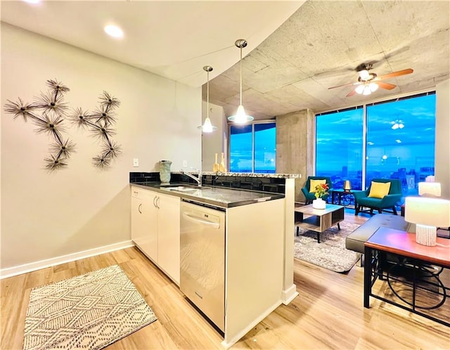 kitchen featuring dishwasher, sink, hanging light fixtures, white cabinetry, and light hardwood / wood-style floors