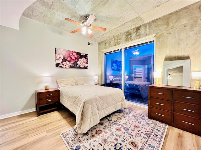 bedroom with access to outside, light hardwood / wood-style floors, and ceiling fan