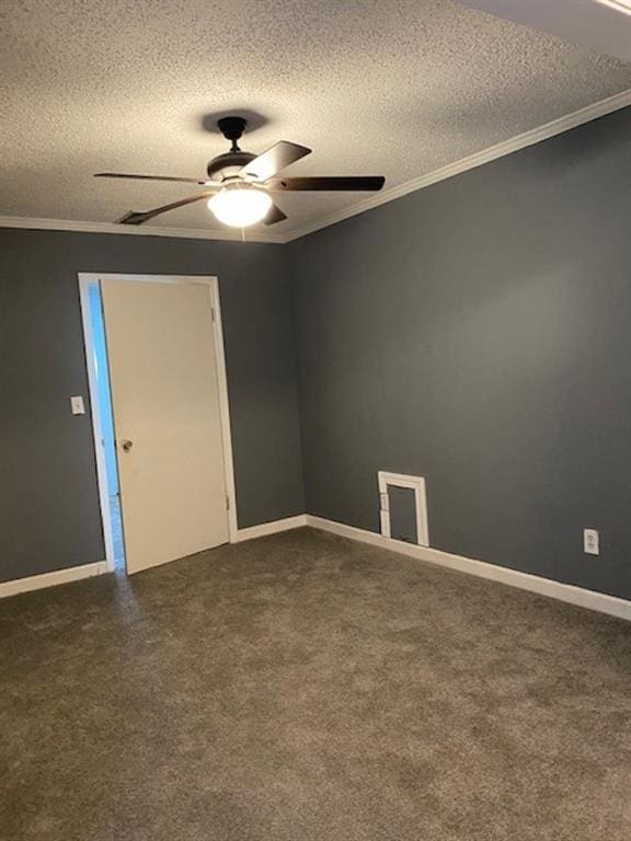 spare room with a textured ceiling, dark carpet, ceiling fan, and crown molding