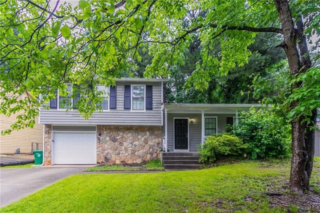 4766 White Oak Path, Stone Mountain, GA 30088 - split level home with stone siding, a front yard, an attached garage, covered porch, and asphalt driveway