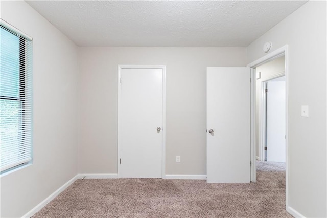 4766 White Oak Path, Stone Mountain, GA 30088 - unfurnished bedroom featuring carpet floors, a textured ceiling, and baseboards