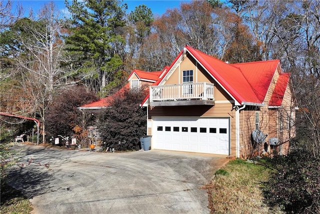 view of home's exterior with a garage and a balcony