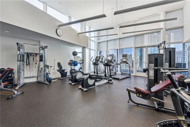 3325 Piedmont Rd NE Unit 1708, Atlanta, GA 30305 - exercise room featuring a towering ceiling, a wall of windows, and plenty of natural light
