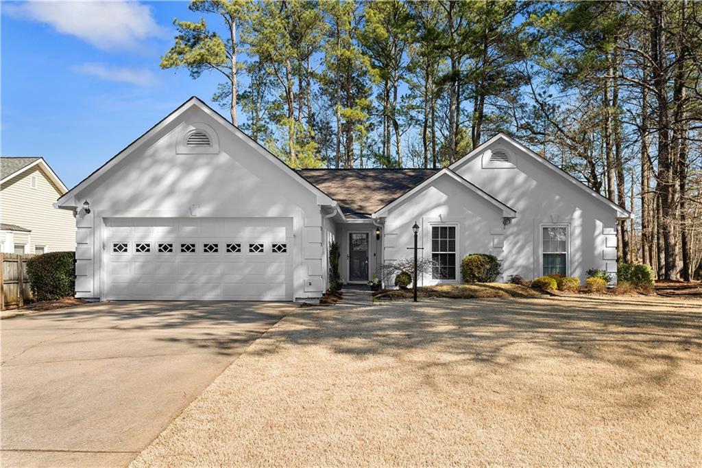 ranch-style house with a garage and concrete driveway
