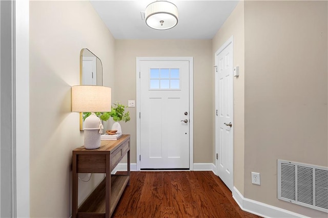 entryway with visible vents, baseboards, and wood finished floors