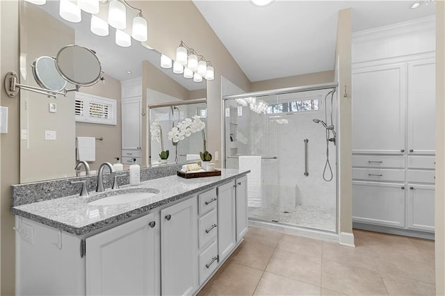 bathroom featuring crown molding, a stall shower, vanity, and tile patterned flooring