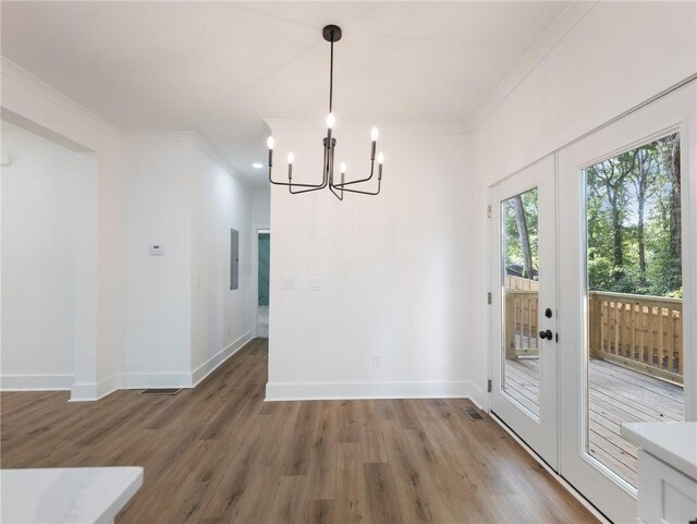 unfurnished dining area with crown molding, french doors, and dark hardwood / wood-style flooring