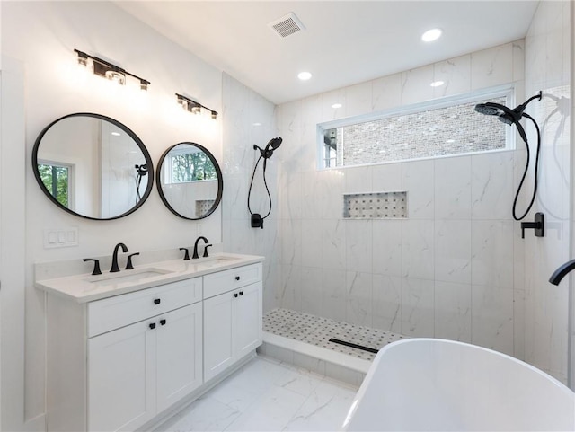 bathroom with plus walk in shower, vanity, and a healthy amount of sunlight