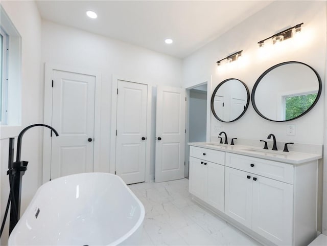 bathroom with vanity and a bathtub