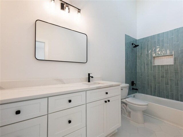 full bathroom with tiled shower / bath, vanity, toilet, and tile patterned floors