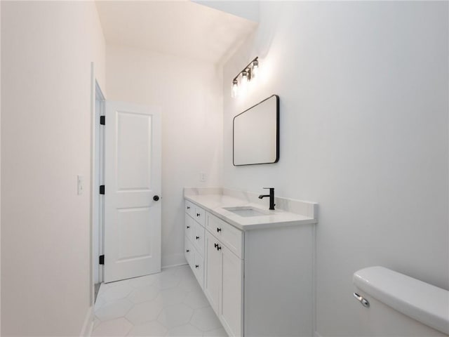 bathroom with vanity, toilet, and tile patterned floors