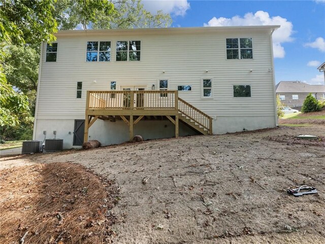 rear view of property with a wooden deck and central AC