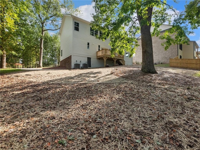 rear view of house featuring central AC