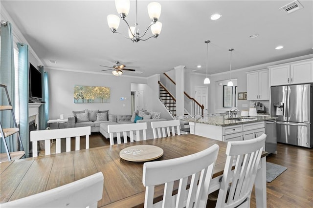 4568 Mantova Dr, Buford, GA 30519 - dining space featuring stairs, a ceiling fan, ornamental molding, recessed lighting, and a fireplace