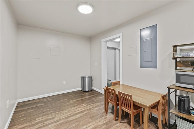 4568 Mantova Dr, Buford, GA 30519 - dining room featuring electric panel, wood finished floors, and baseboards