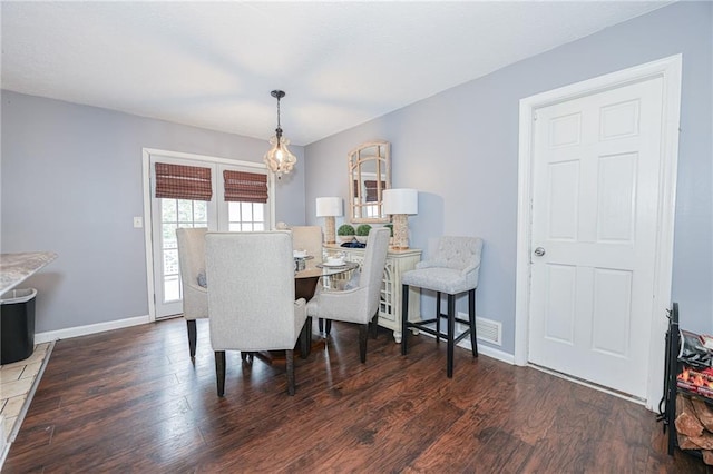 dining area featuring baseboards and wood finished floors