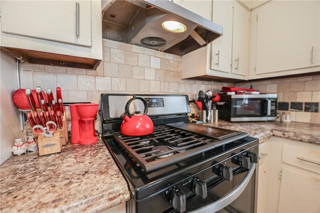 kitchen featuring under cabinet range hood, stainless steel appliances, and decorative backsplash