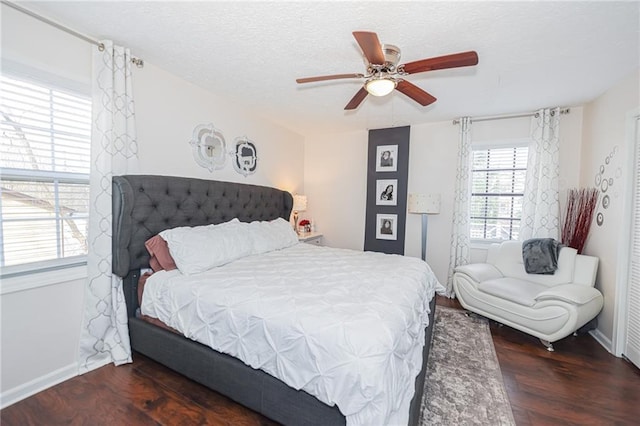 bedroom with a textured ceiling, wood finished floors, a ceiling fan, and baseboards