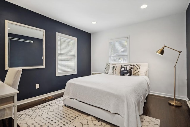 bedroom featuring dark wood-type flooring and multiple windows