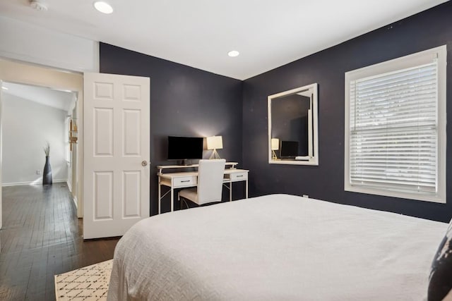 bedroom featuring lofted ceiling and dark hardwood / wood-style floors