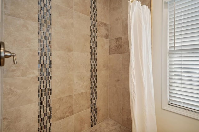 interior details featuring a shower with curtain