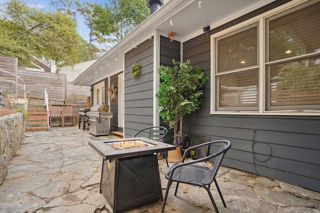 view of patio with grilling area and a fire pit