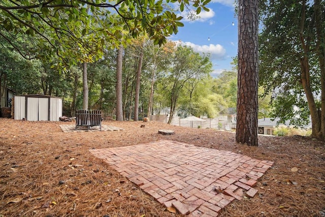 view of patio featuring a storage unit