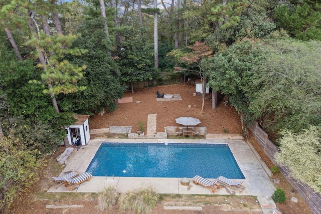 view of pool featuring an outbuilding and a patio area