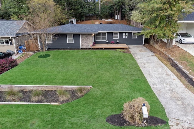 ranch-style home featuring a front yard and a deck