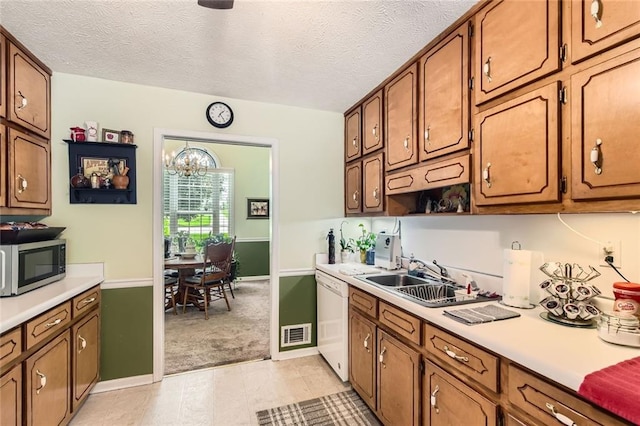 180 Moseley Crossing Dr, Stockbridge, GA 30281 - kitchen with stainless steel microwave, dishwasher, light countertops, light colored carpet, and brown cabinetry