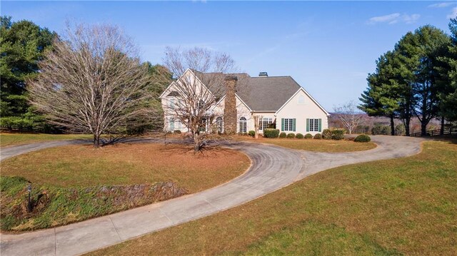 5414 Price Rd, Gainesville, GA 30506 - view of front facade featuring stucco siding, curved driveway, a chimney, and a front yard