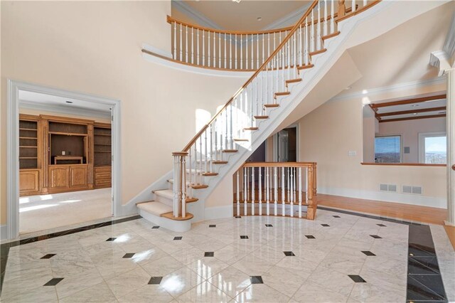 5414 Price Rd, Gainesville, GA 30506 - stairs featuring visible vents, baseboards, a towering ceiling, and ornamental molding