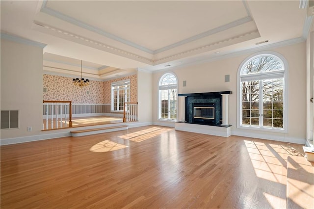5414 Price Rd, Gainesville, GA 30506 - unfurnished living room featuring a premium fireplace, visible vents, a raised ceiling, and wood finished floors