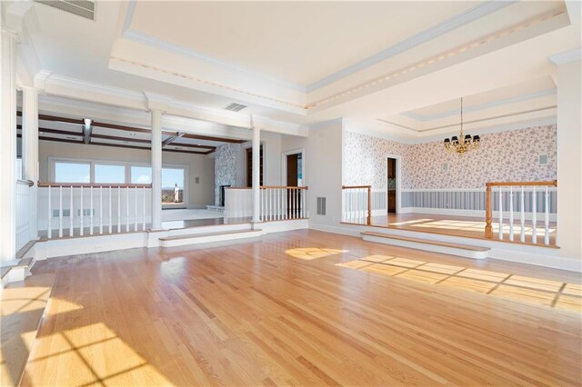 5414 Price Rd, Gainesville, GA 30506 - unfurnished room with a tray ceiling, wood finished floors, wallpapered walls, a chandelier, and ornate columns