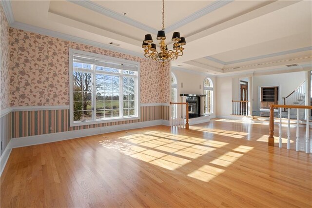 5414 Price Rd, Gainesville, GA 30506 - unfurnished dining area with wallpapered walls, ornamental molding, wood finished floors, a notable chandelier, and a raised ceiling