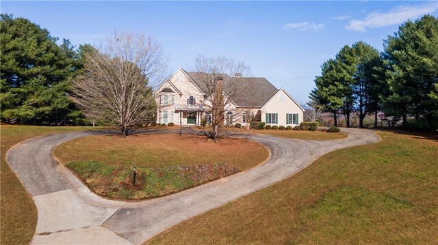 5414 Price Rd, Gainesville, GA 30506 - view of front of house with a front lawn, a chimney, and curved driveway
