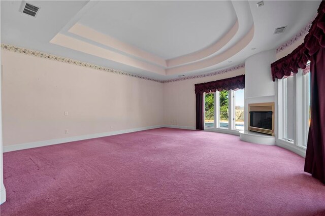 5414 Price Rd, Gainesville, GA 30506 - unfurnished living room featuring visible vents, a raised ceiling, baseboards, and a glass covered fireplace