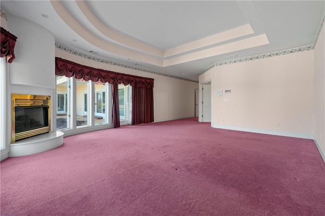 5414 Price Rd, Gainesville, GA 30506 - empty room featuring a glass covered fireplace, a raised ceiling, carpet, and baseboards