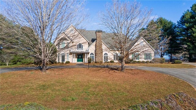 5414 Price Rd, Gainesville, GA 30506 - view of front of home featuring curved driveway, a chimney, and a front lawn