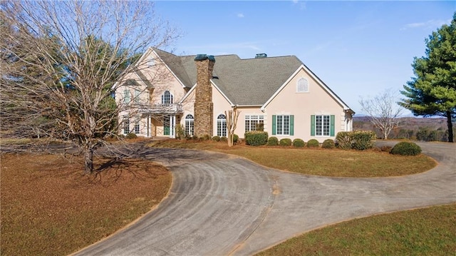 5414 Price Rd, Gainesville, GA 30506 - view of front of house featuring stucco siding, curved driveway, a chimney, and a front yard