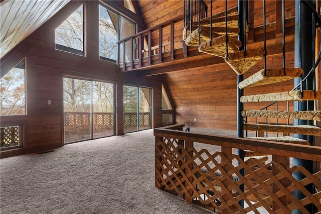 5414 Price Rd, Gainesville, GA 30506 - stairs featuring a high ceiling, wood walls, and carpet floors
