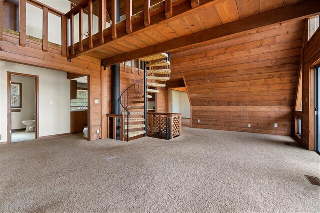 5414 Price Rd, Gainesville, GA 30506 - unfurnished living room featuring visible vents, carpet floors, a high ceiling, and wood walls