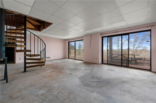 5414 Price Rd, Gainesville, GA 30506 - unfurnished living room with a drop ceiling, stairs, unfinished concrete flooring, and visible vents