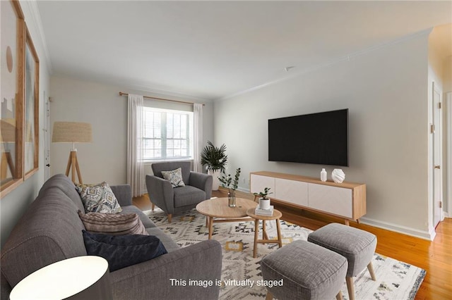 living room featuring wood finished floors, baseboards, and ornamental molding