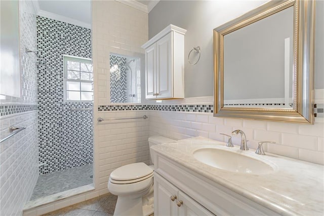 bathroom featuring a walk in shower, tile walls, toilet, ornamental molding, and vanity