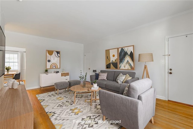 living area featuring ornamental molding, baseboards, and wood finished floors