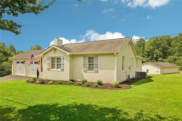 view of front of home featuring a garage, a front yard, and cooling unit